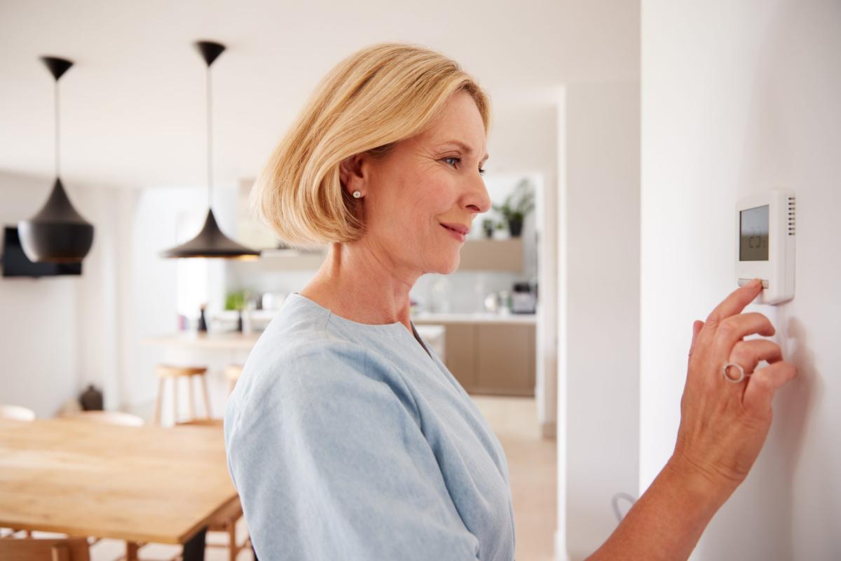 Person Using Thermostat